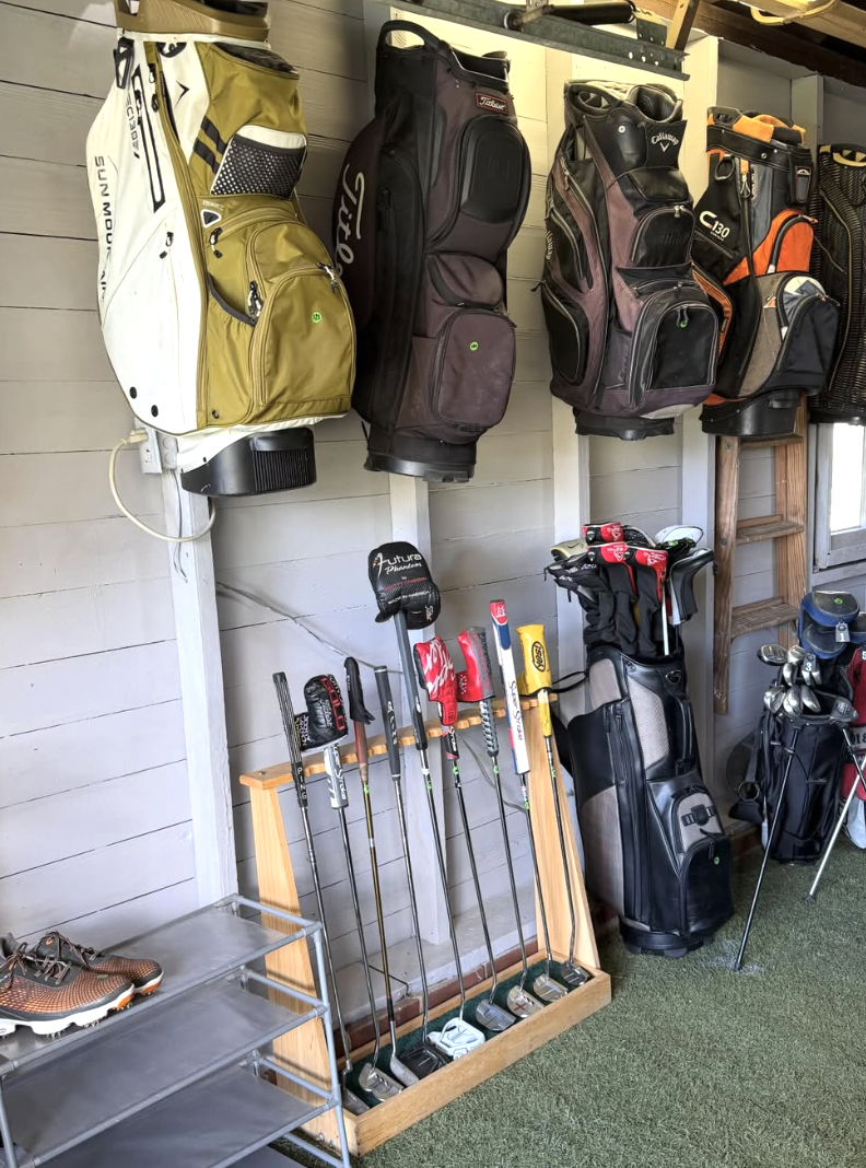 Golf bags and putters inside the shop